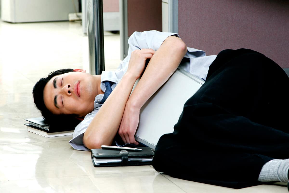 College student sleeping on the floor