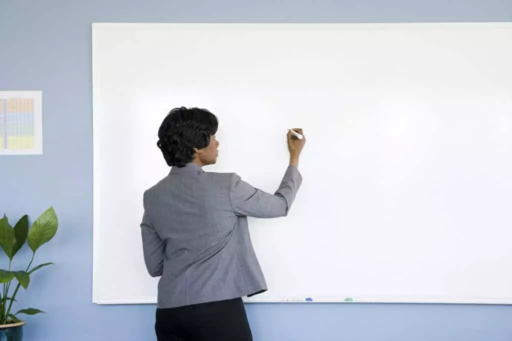 teacher writing on whiteboard